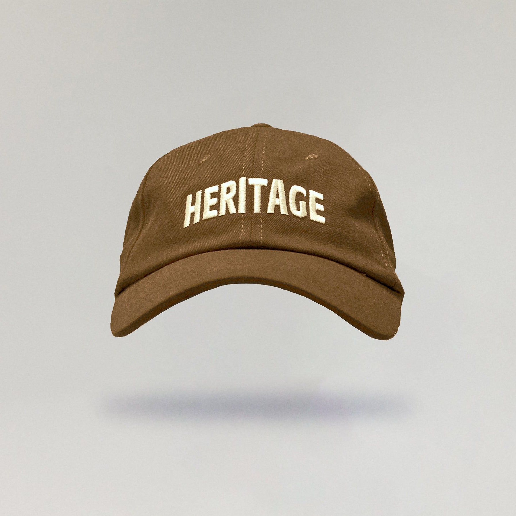 Brown cap with 'HERITAGE' text on a light gray background
