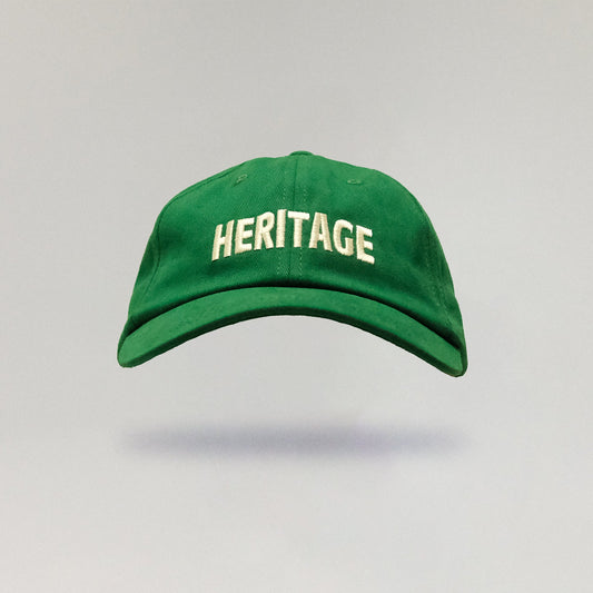 Green cap with 'HERITAGE' text on a gray background